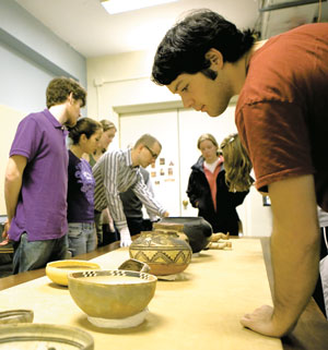 Students examine objects during museum class.